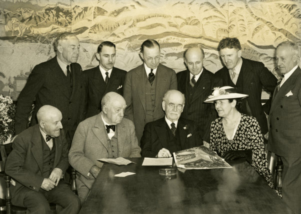 Historic photo of people at meeting table